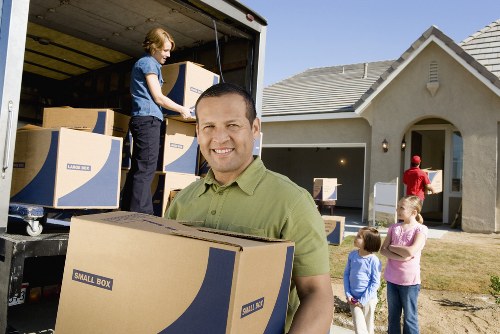 Professional movers handling office equipment during a Roehampton business move