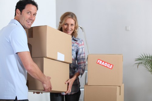 Professional movers handling a flat move in Roehampton with boxes and furniture